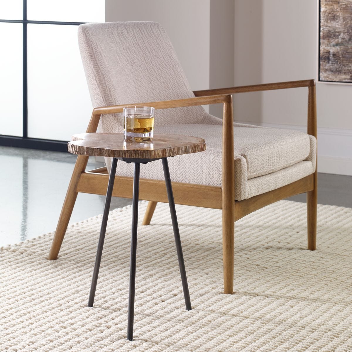 Beige armchair with a small wooden table on a textured rug