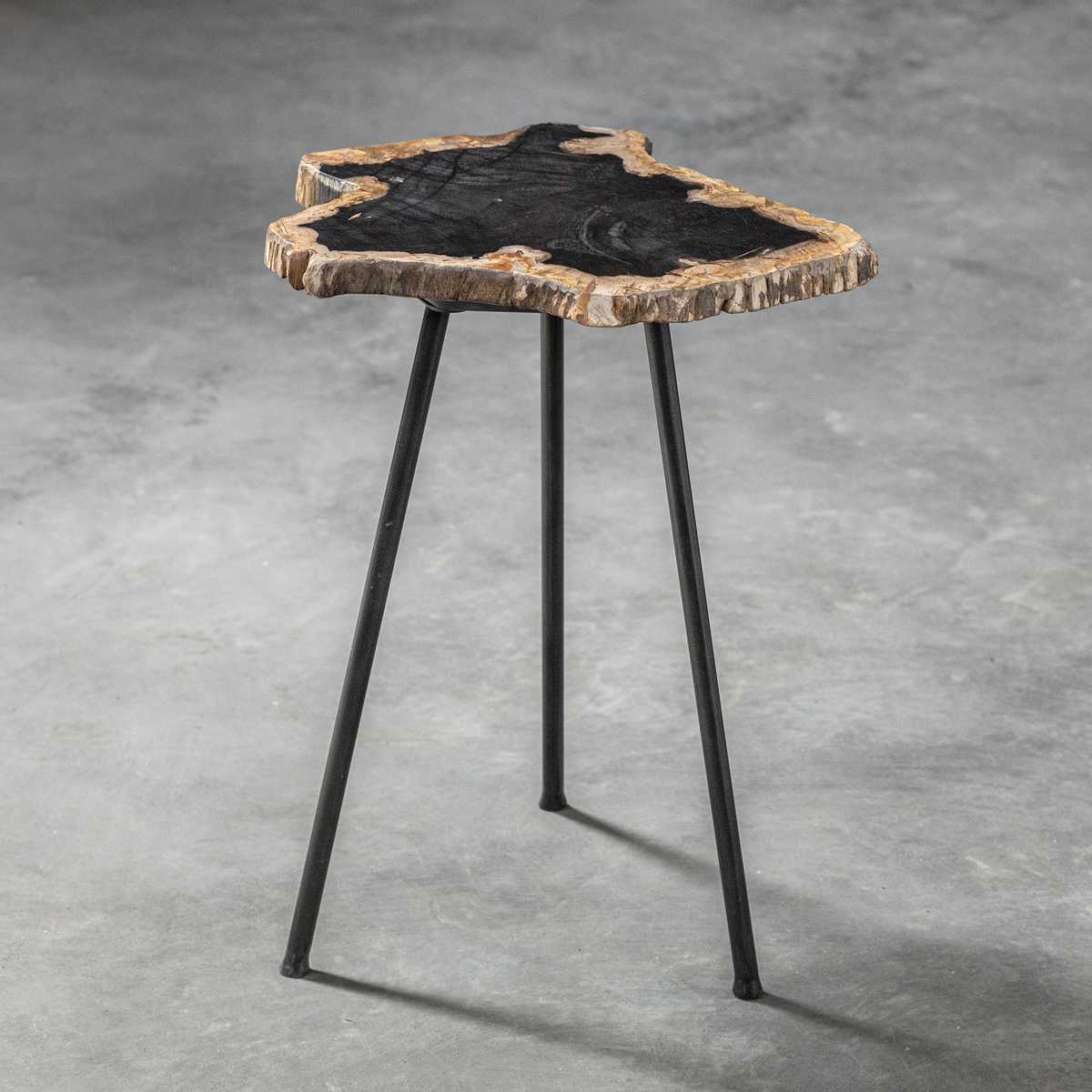 Small side table with a natural wood top and black metal legs on a gray concrete background