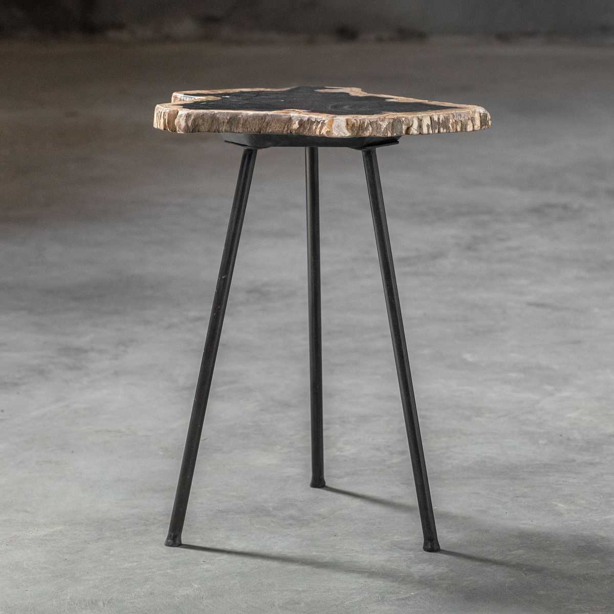 Small hexagonal table with a wooden top and metal legs on a gray concrete floor.