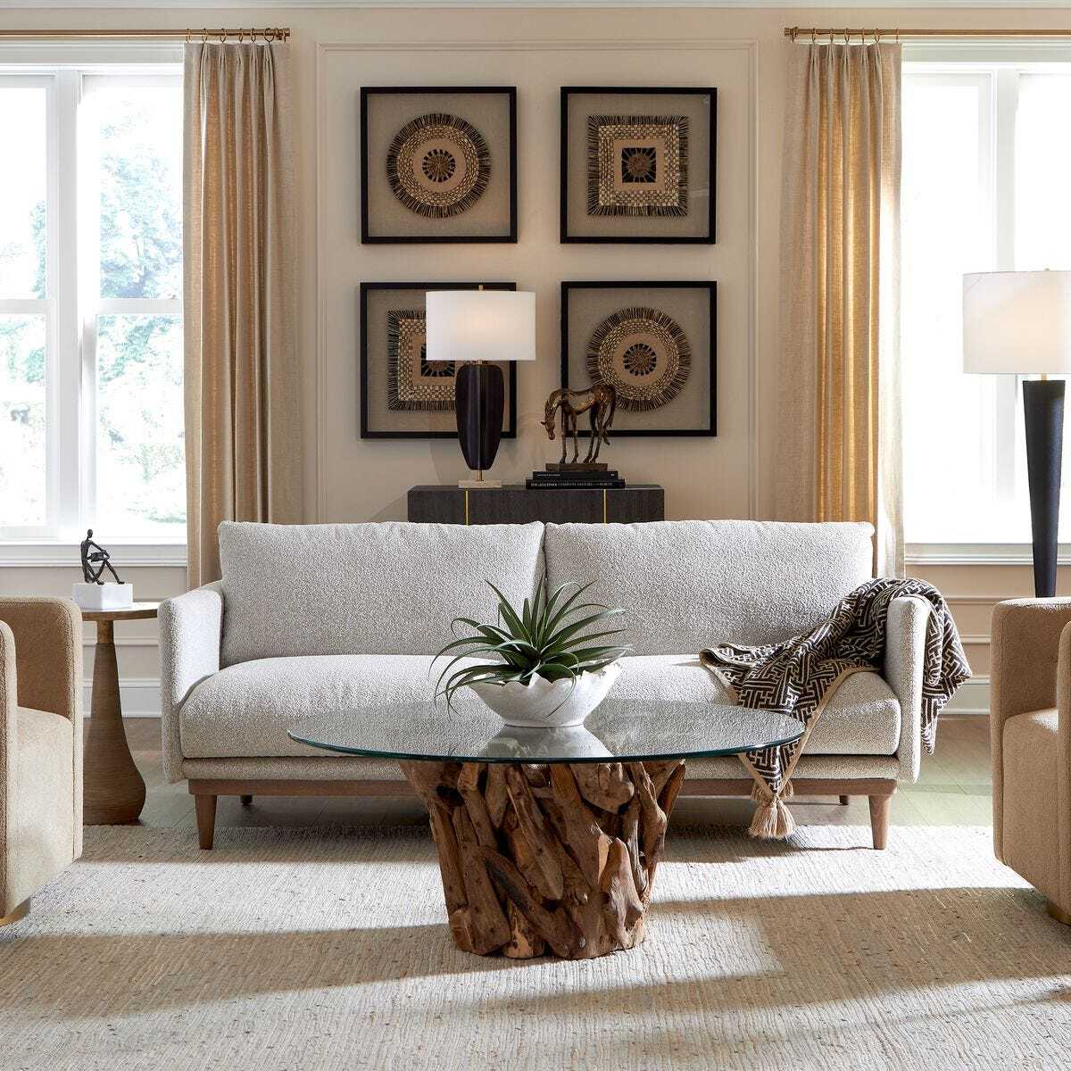 Living room with a gray sofa, wooden coffee table, and decorative elements.