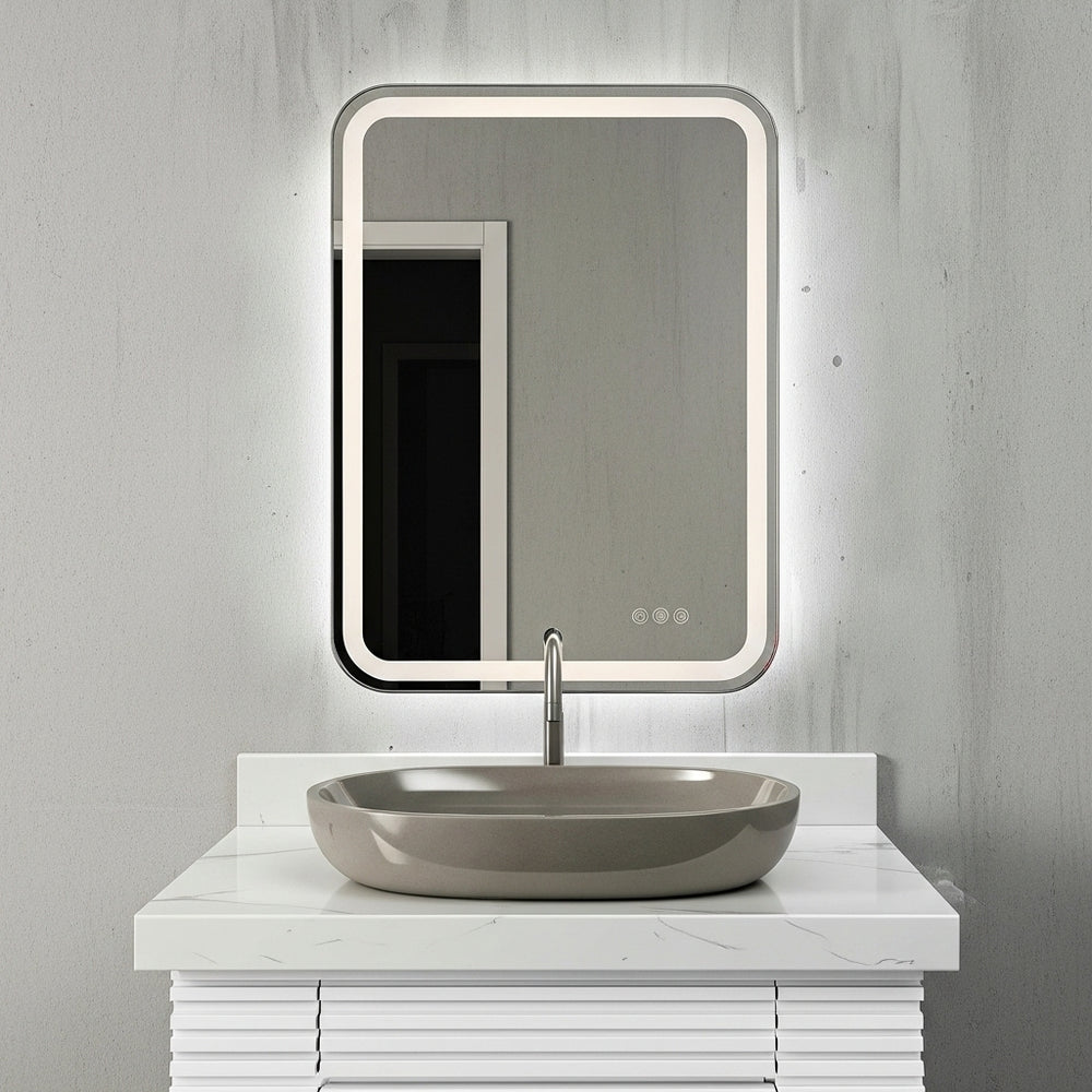 Polished Nickel Lighted Mirror in a Moder Brutalist Bathroom with White Vanity.