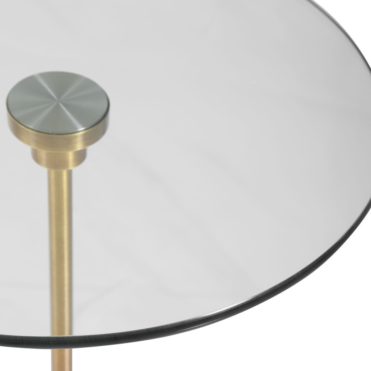 Glass side table with metallic base on a white background