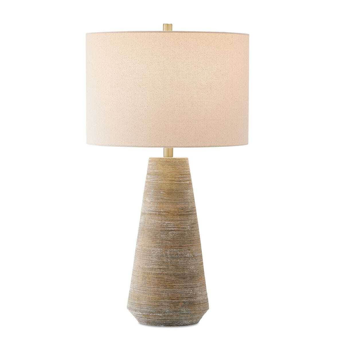 Table lamp with textured base and beige shade on a white background