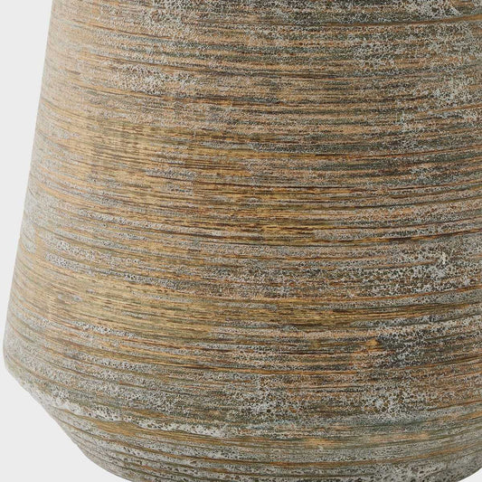 Table lamp with textured ceramic base and beige fabric shade on a white background