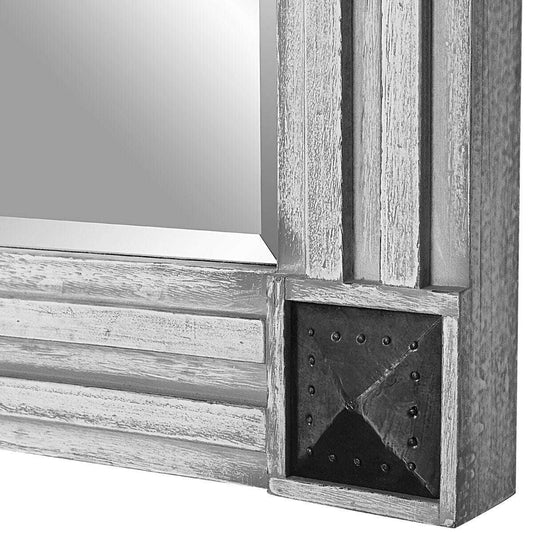Rectangular mirror with decorative silver frame on a white background