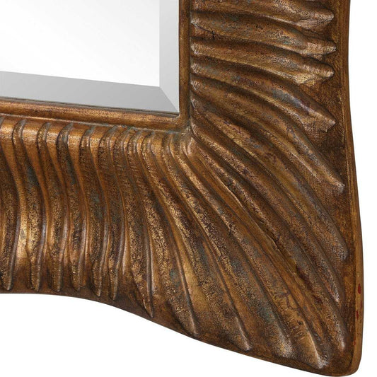 Decorative mirror with gold frame on a dark wooden console table.
