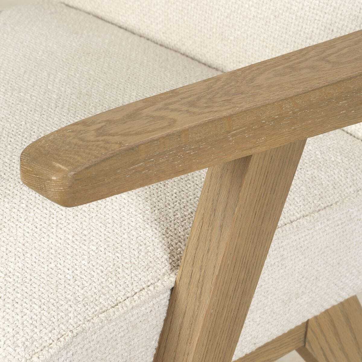 Close-up of a wooden bench seat on a textured white surface