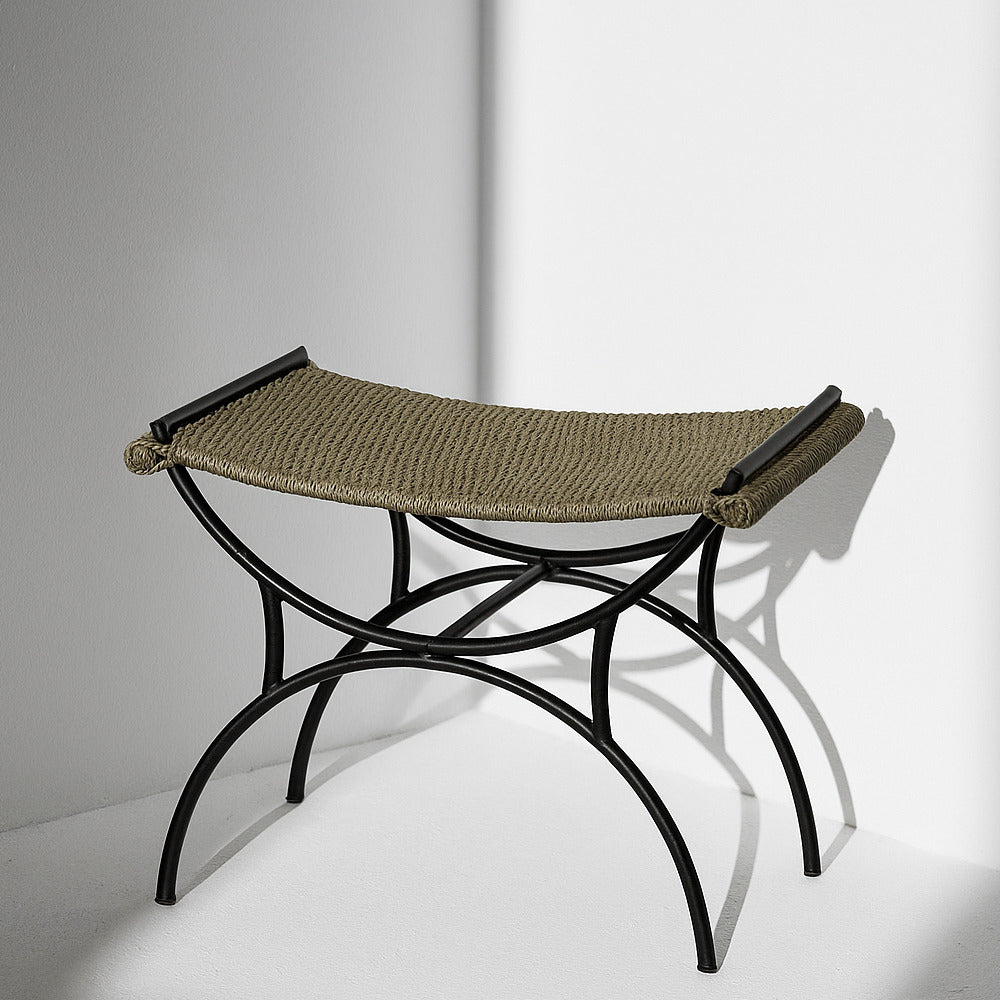 Seagrass bench seat with iron frame in a modern white living room.