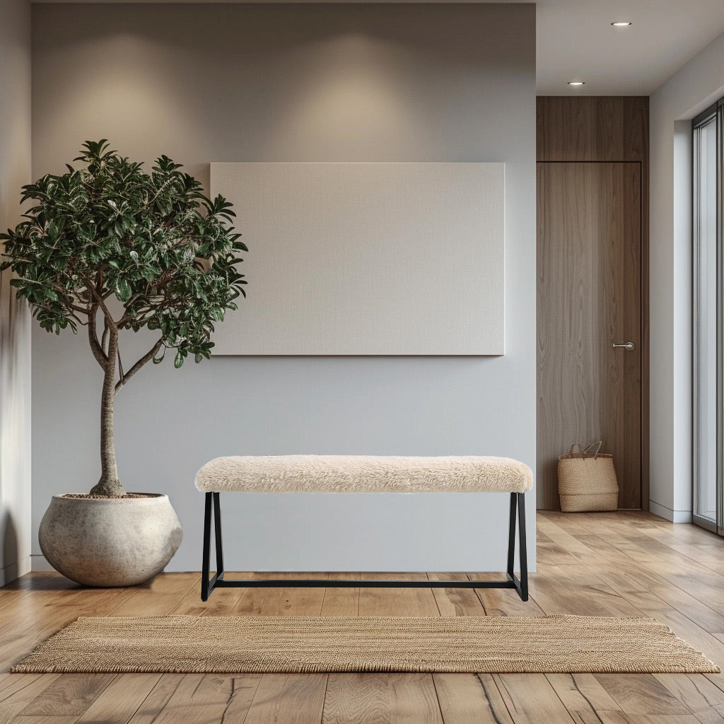 White sherpa bench in wabi sabi living room with tan rug.