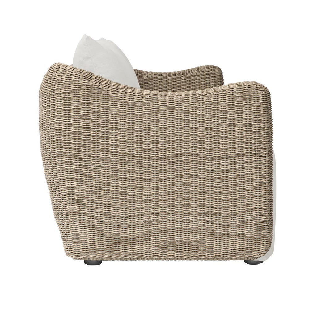 Woven chair with a white cushion on a white background
