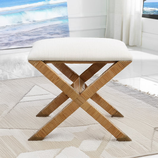 Small coastal rattan bench on white rug.