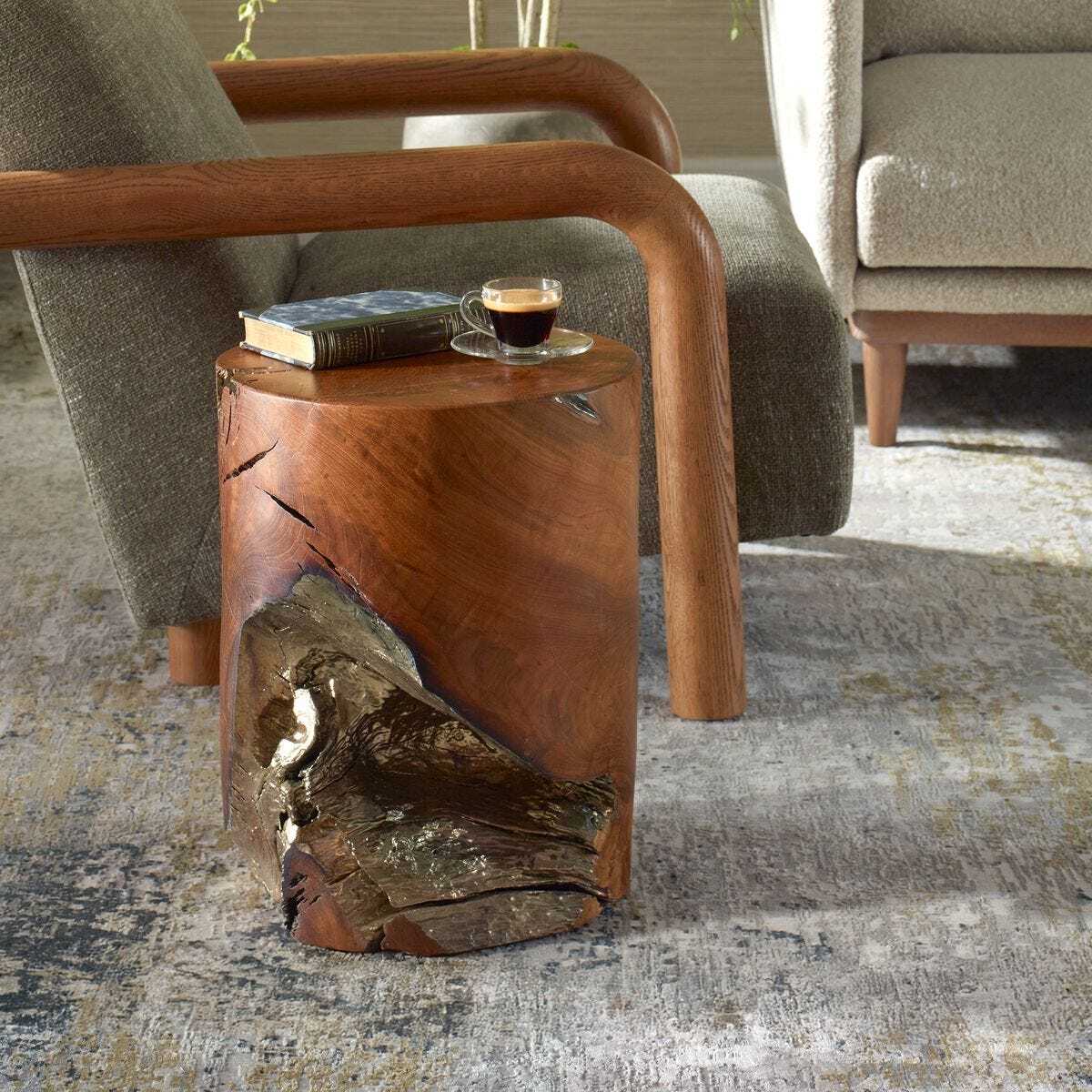 Wooden side table with a natural edge design, featuring a book and a cup of coffee, in a living room setting.