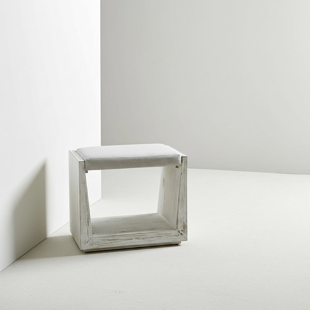 Small white seat in studio.