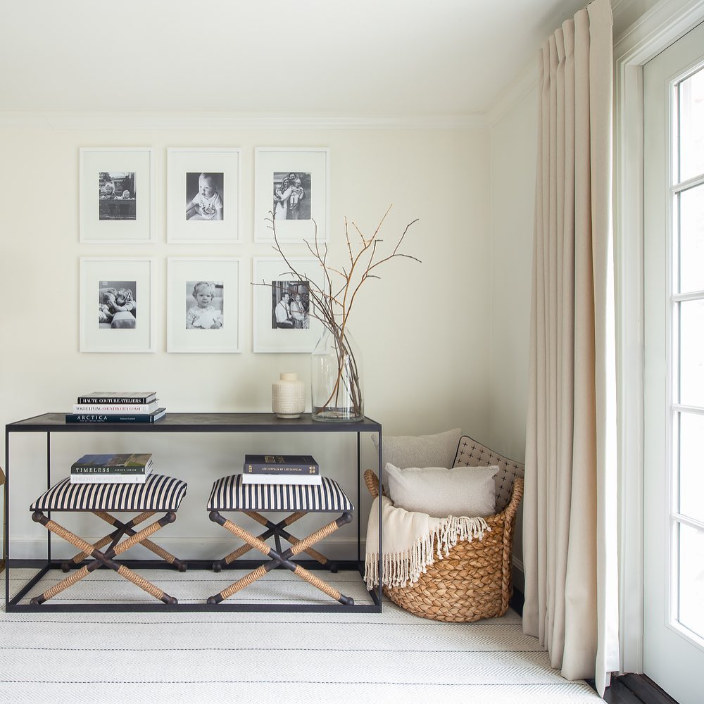Modern interior with a console table, stools, and decorative items.