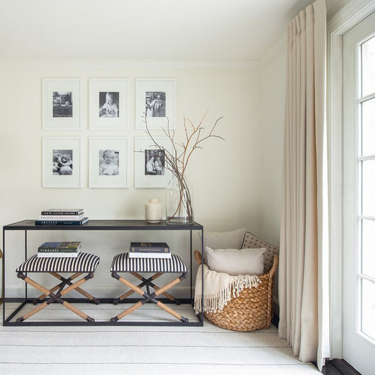 Striped stool with rope legs on a white background