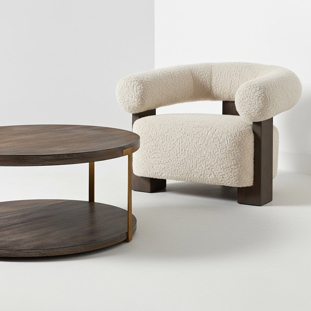 Round wooden coffee table and beige armchair on a white background