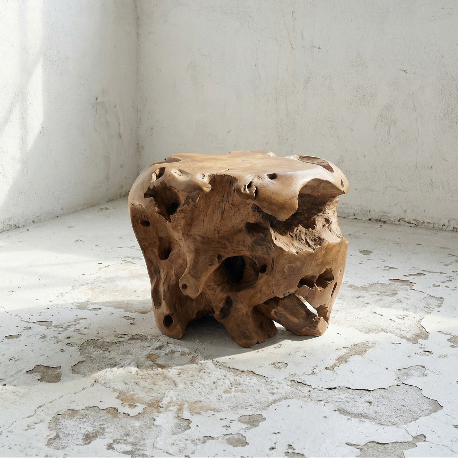 Wooden round teak stool with a natural, textured surface in a minimalistic room.