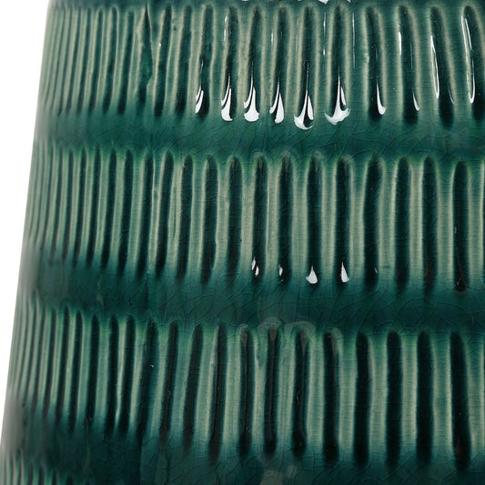 Green ceramic table lamp with white shade in a living room setting
