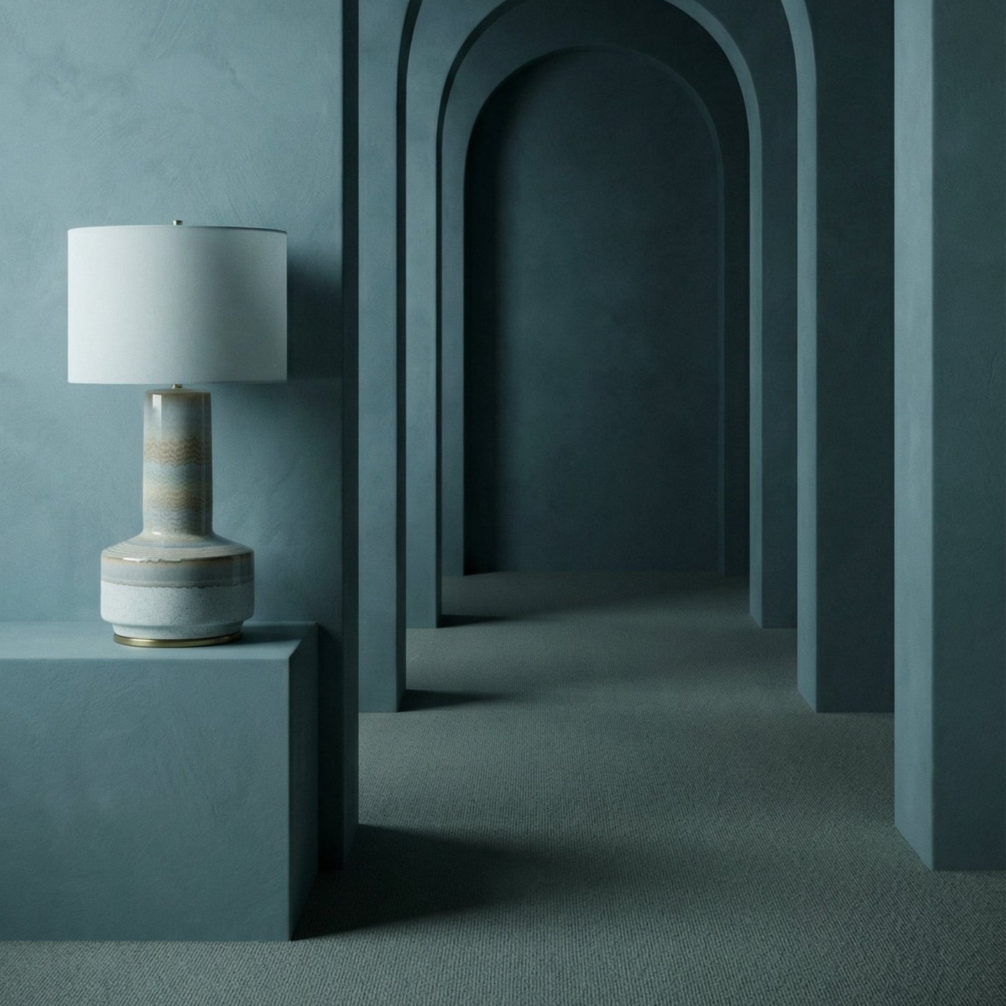 Decorative lamp on a pedestal in front of arches against a dark teal wall