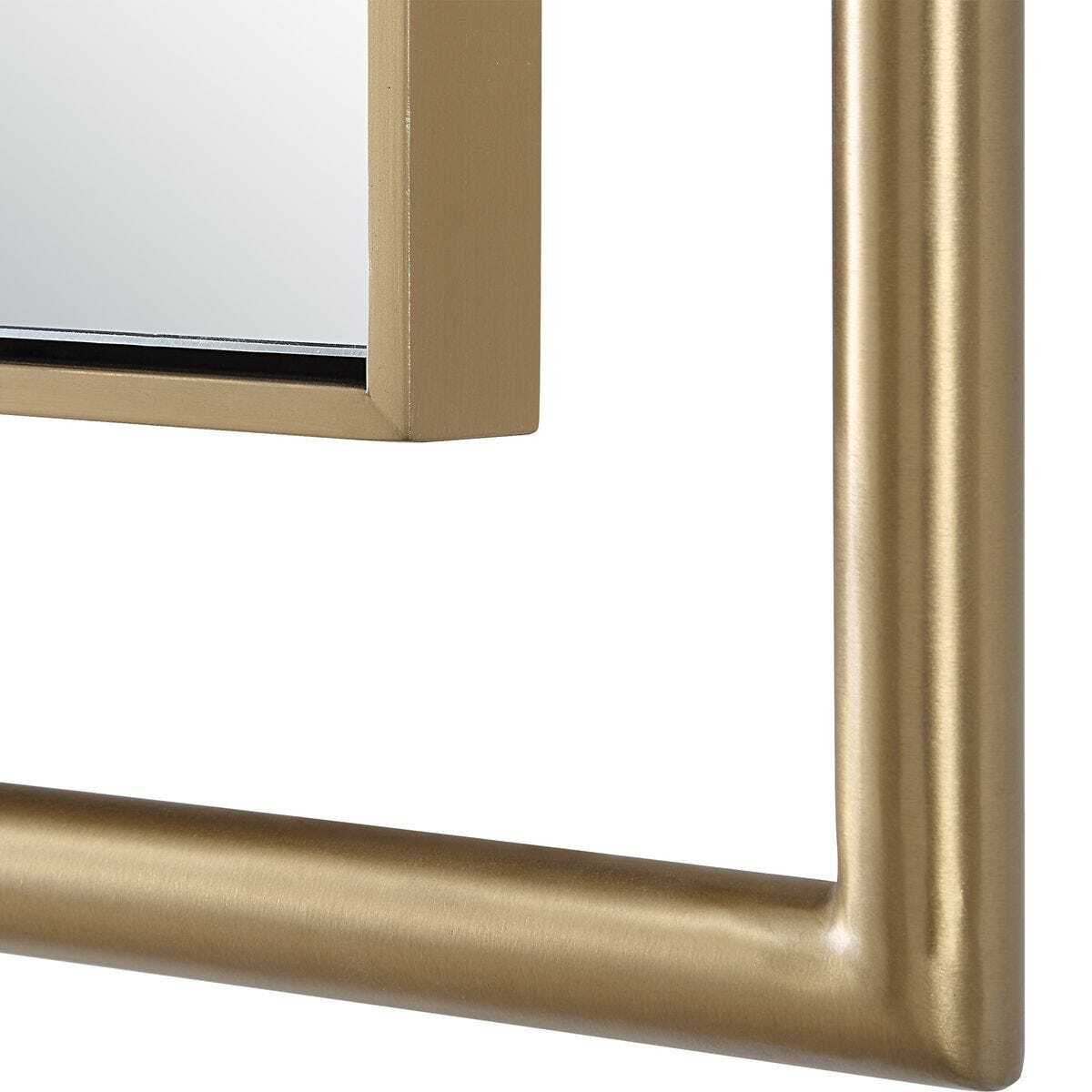 Close-up of a gold-framed mirror on a white background