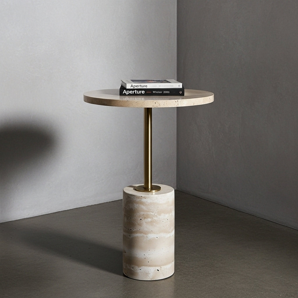 Small round side table with marble top and cylindrical concrete base against a gray wall.