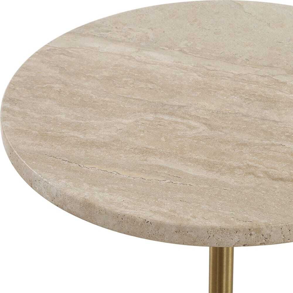 Round travertine table with a gold base on a white background