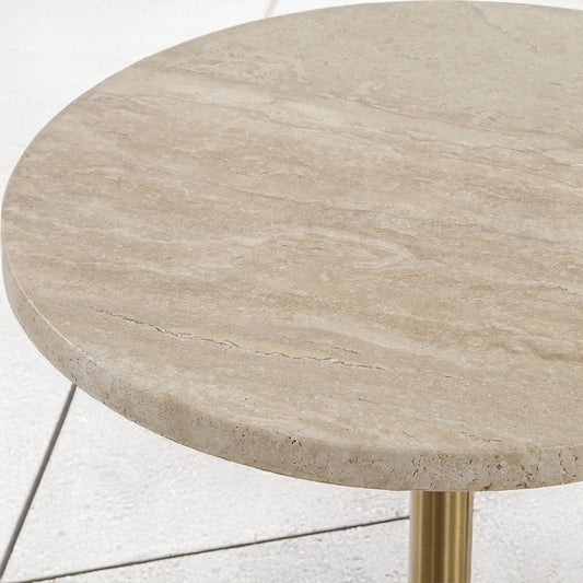 Travertine accent table with iced latter in a living room with a brown decorative chair.