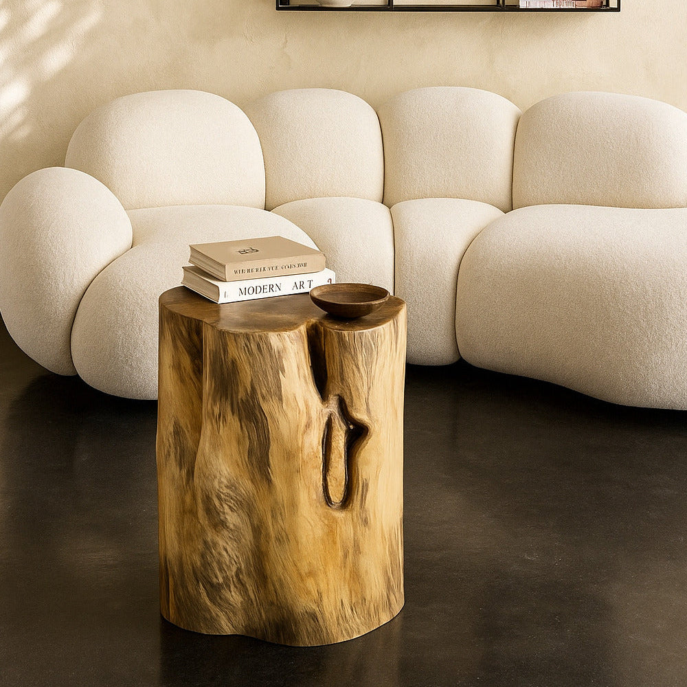 White sofa with a wooden side table and decorative items in a living room setting.