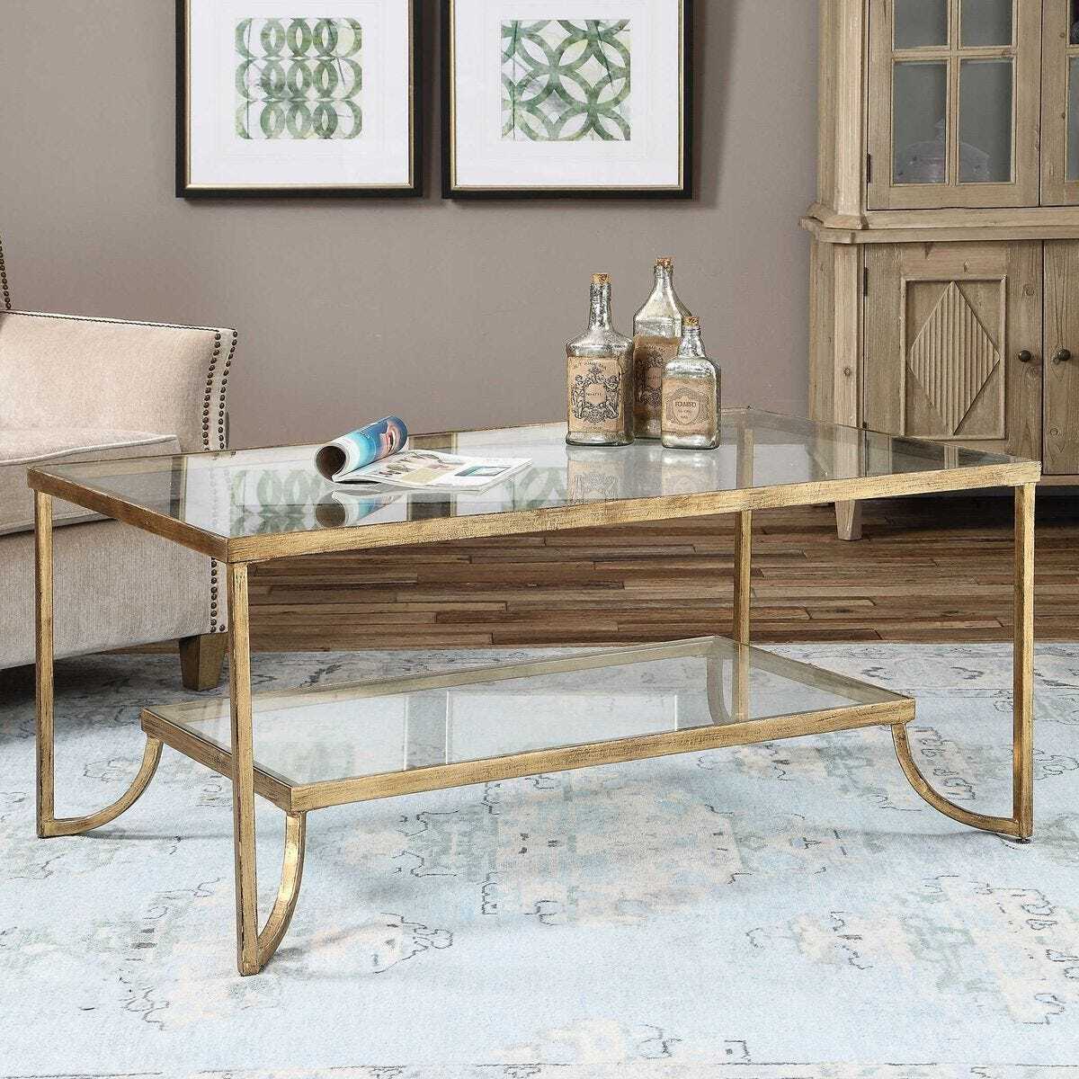 Gold coffee table with glass top in a living room setting