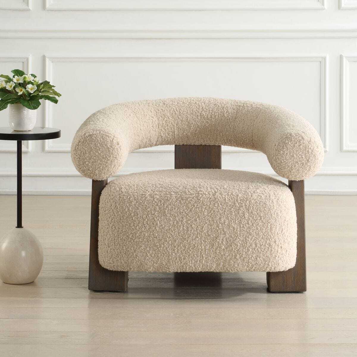 Beige armchair with wooden legs in a room setting
