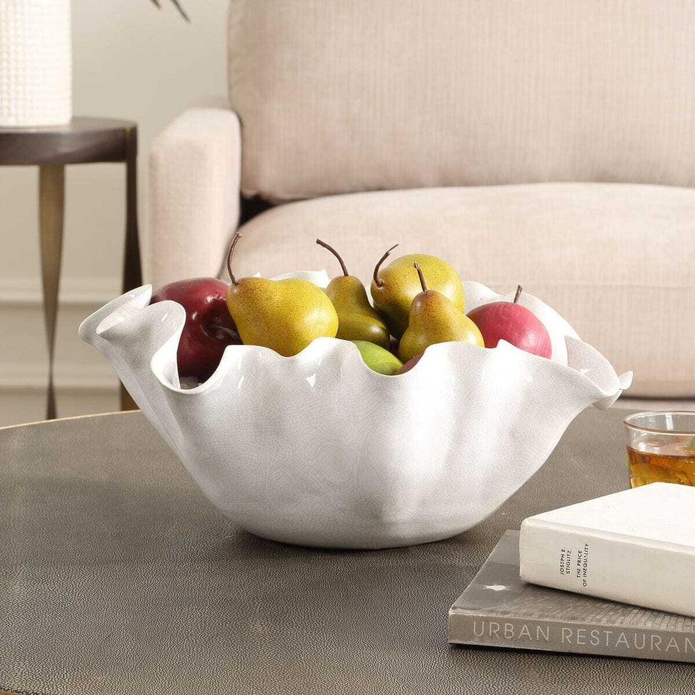 White ceramic bowl with fruits on a coffee table in a living room setting