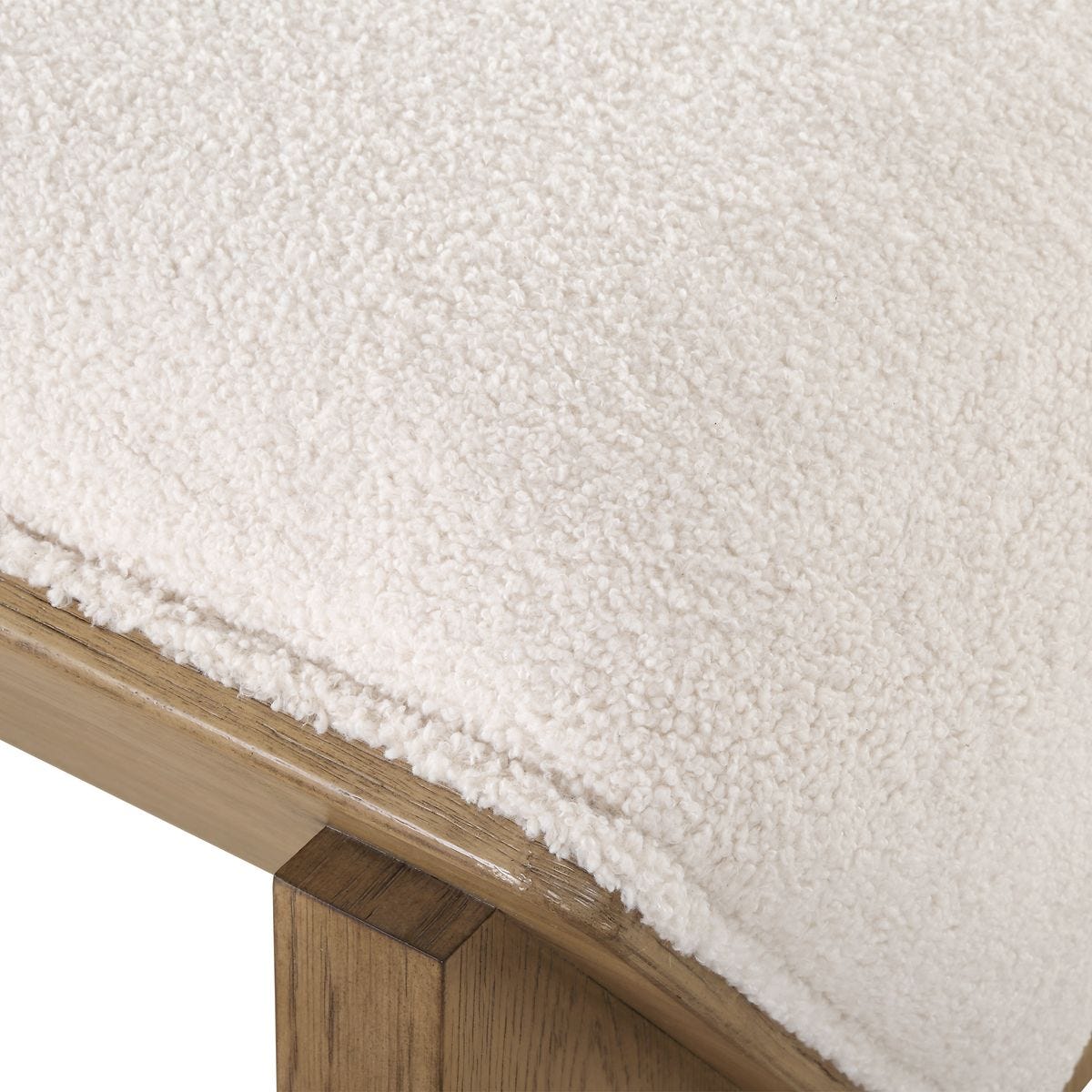 Close-up of a textured white surface with a wooden edge.