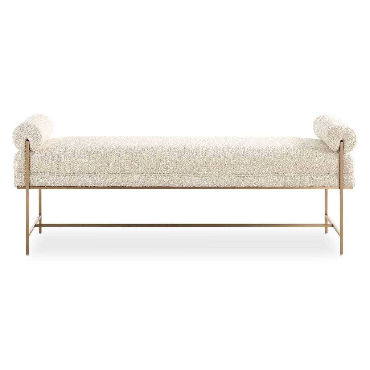 Beige upholstered bench with gold metal frame on a white background