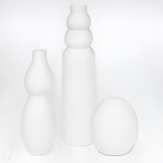 White Ceramic Vases against a white background.