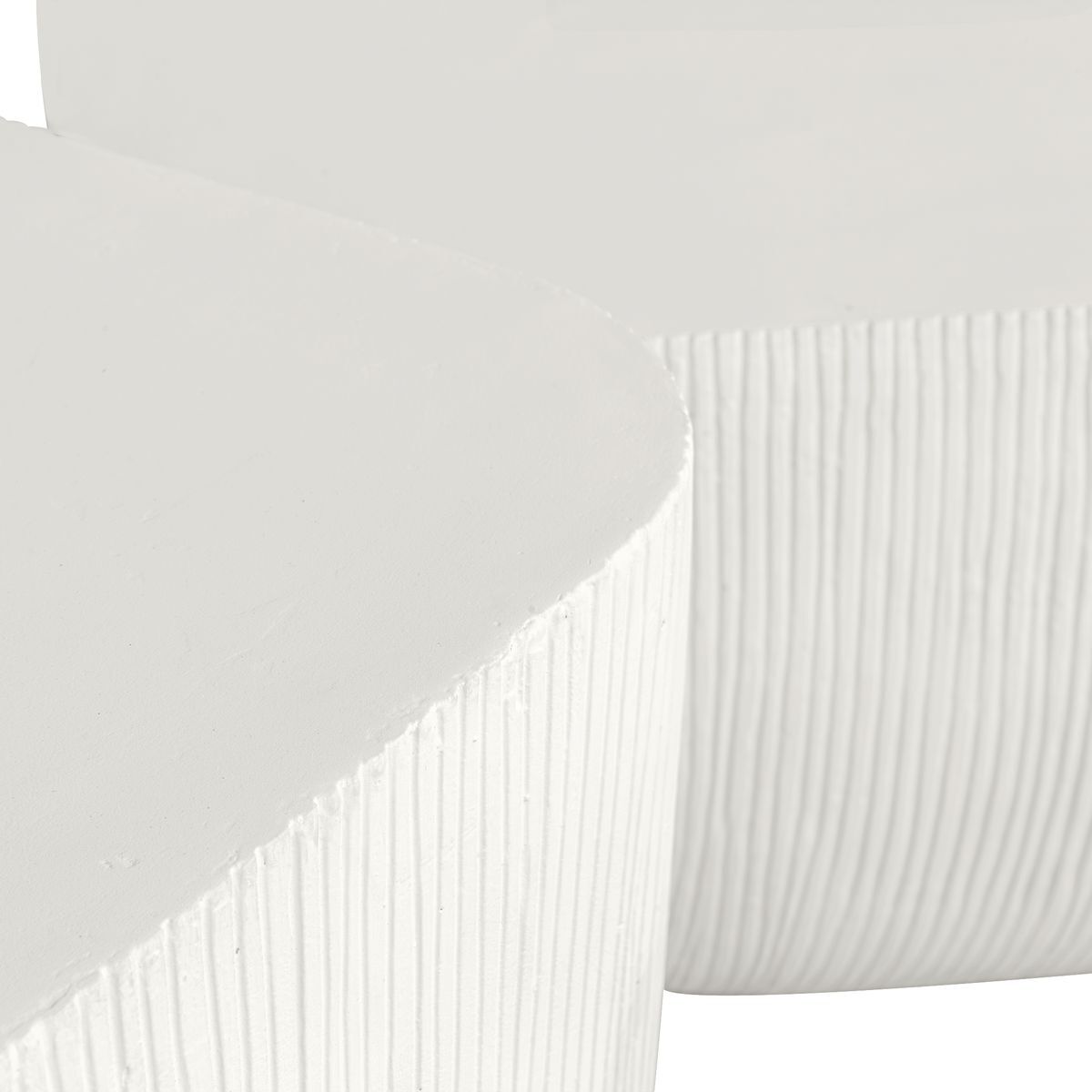 Close-up of white bedding with subtle pattern on a plain background