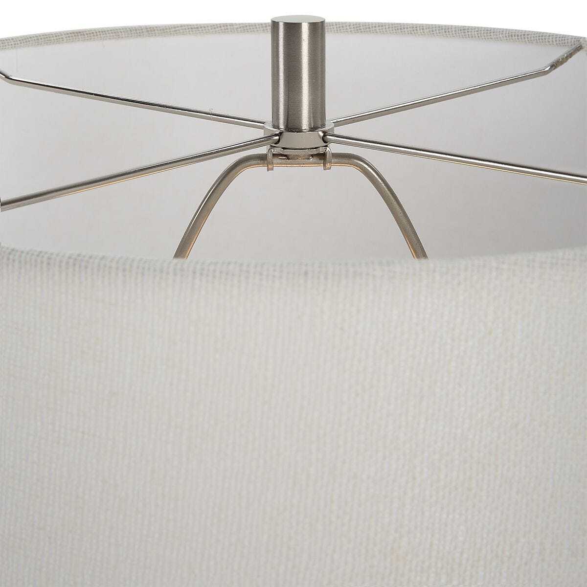 Close-up of a lamp with a metallic base and white fabric shade.