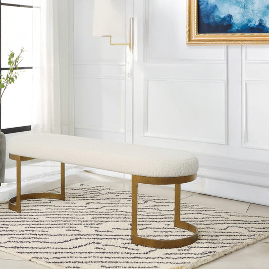 White and gold living room bench with black and white carpet and blue painting.