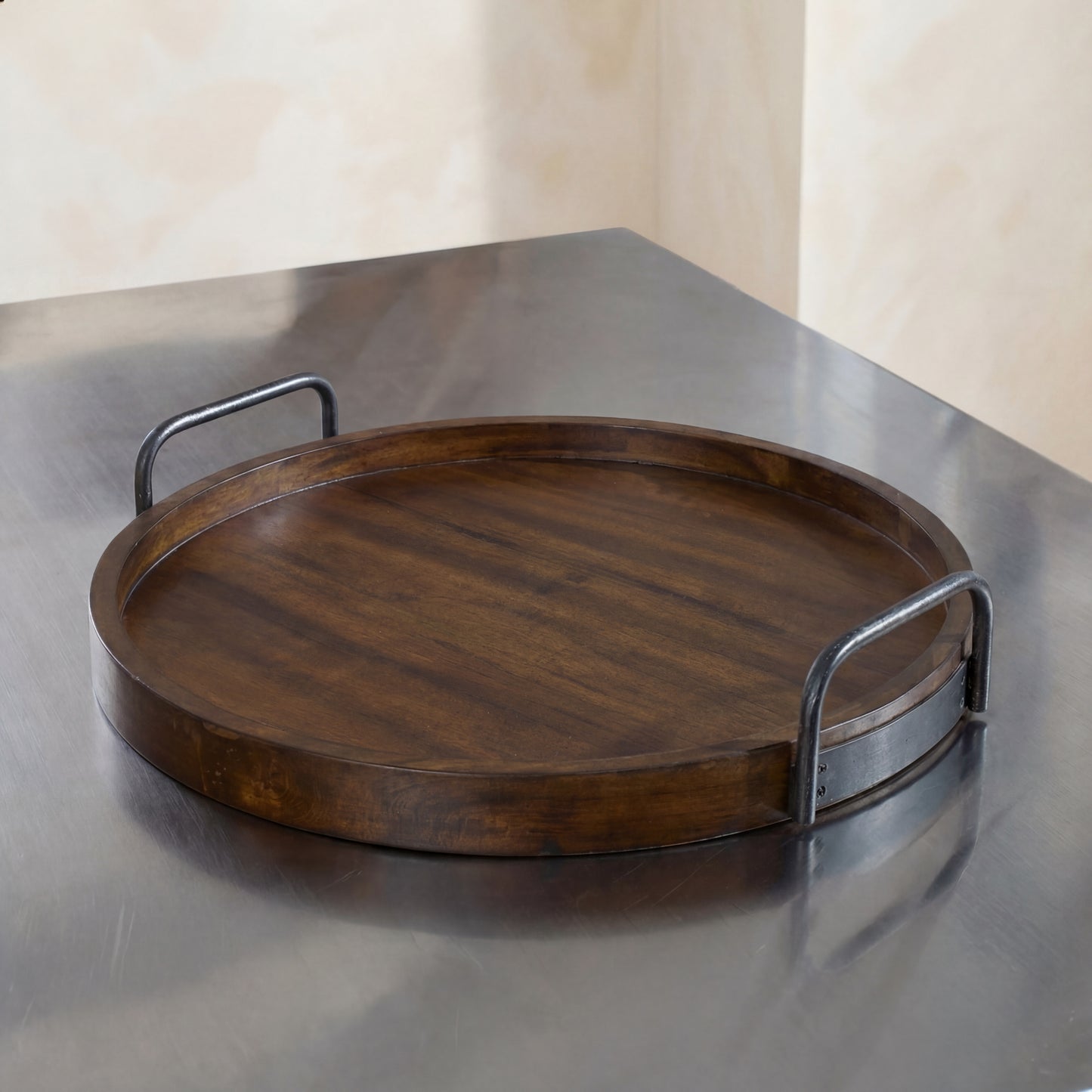 Wooden tray with metal handles on a reflective surface