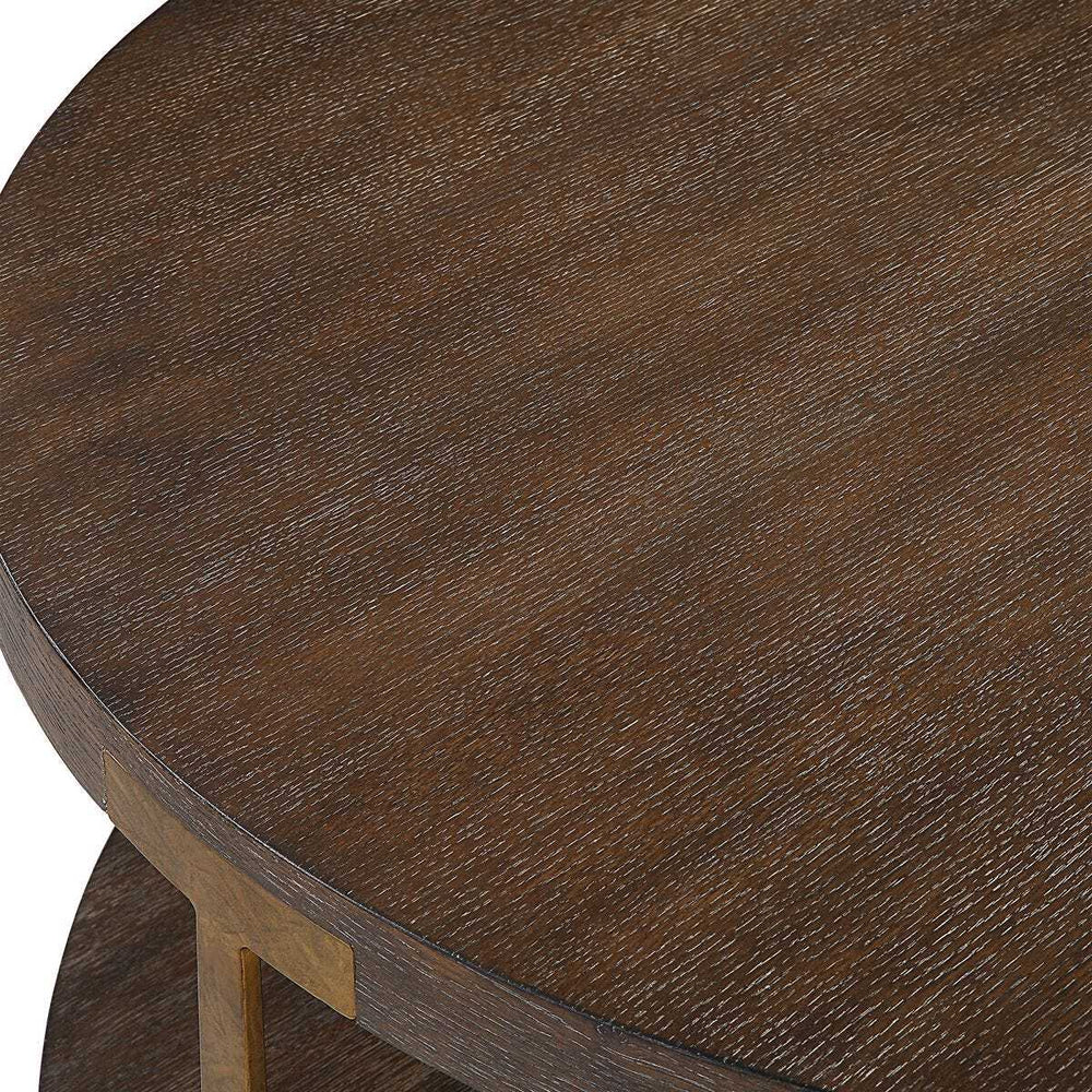Close-up of a wooden round table with a dark brown finish.