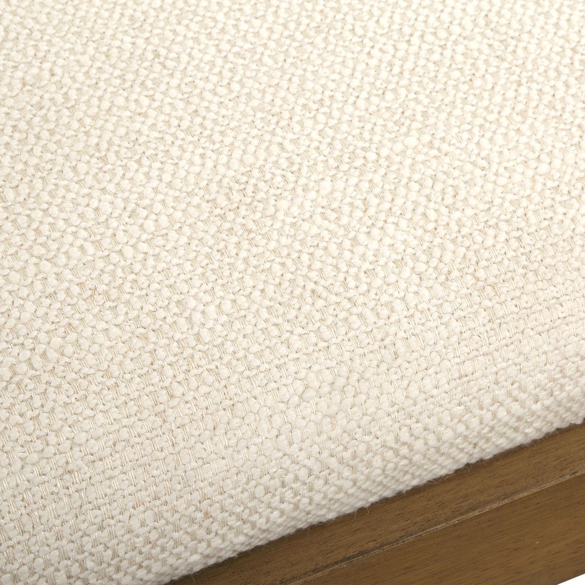 Close-up of beige fabric with a wooden border