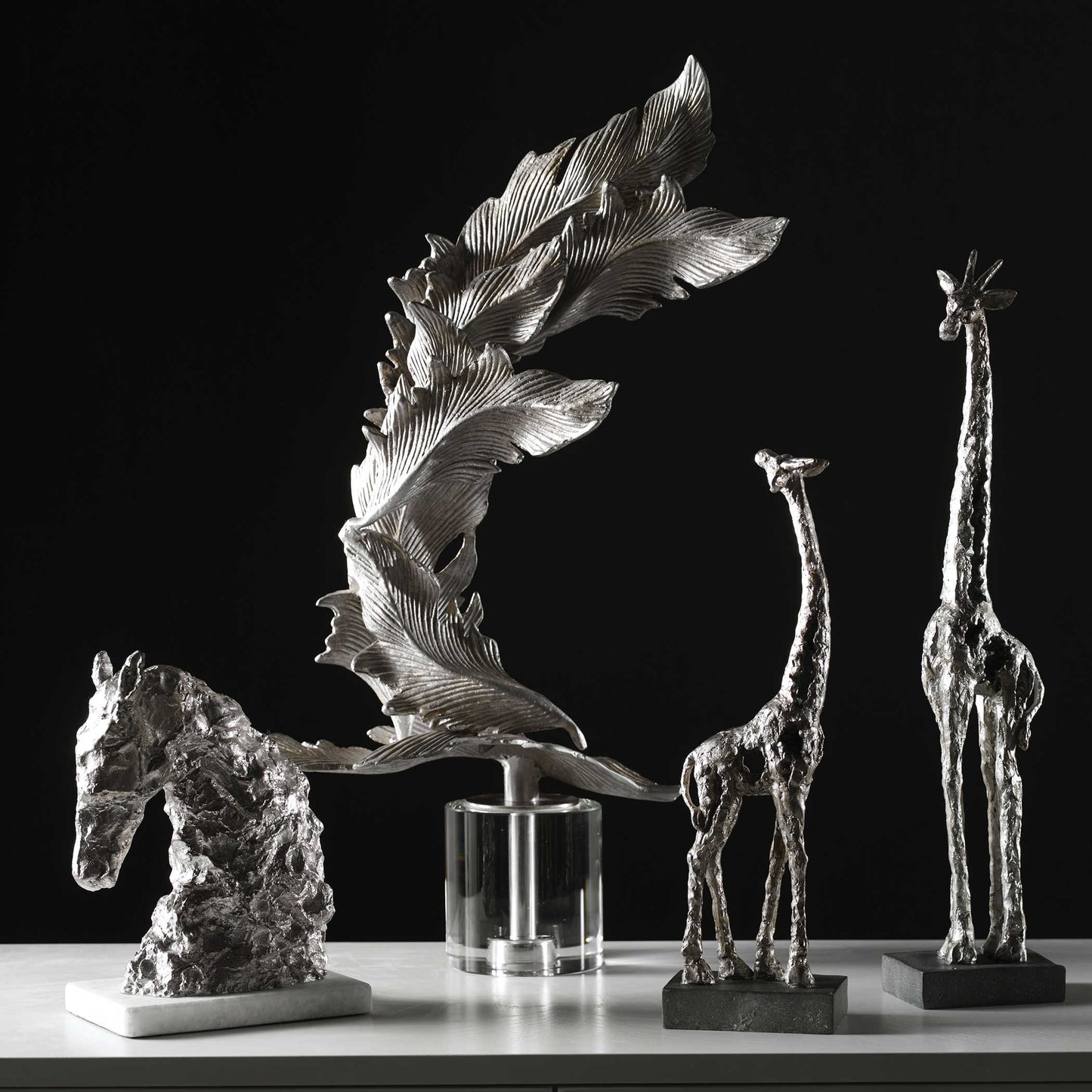 Giraffes posed with other sculptures.