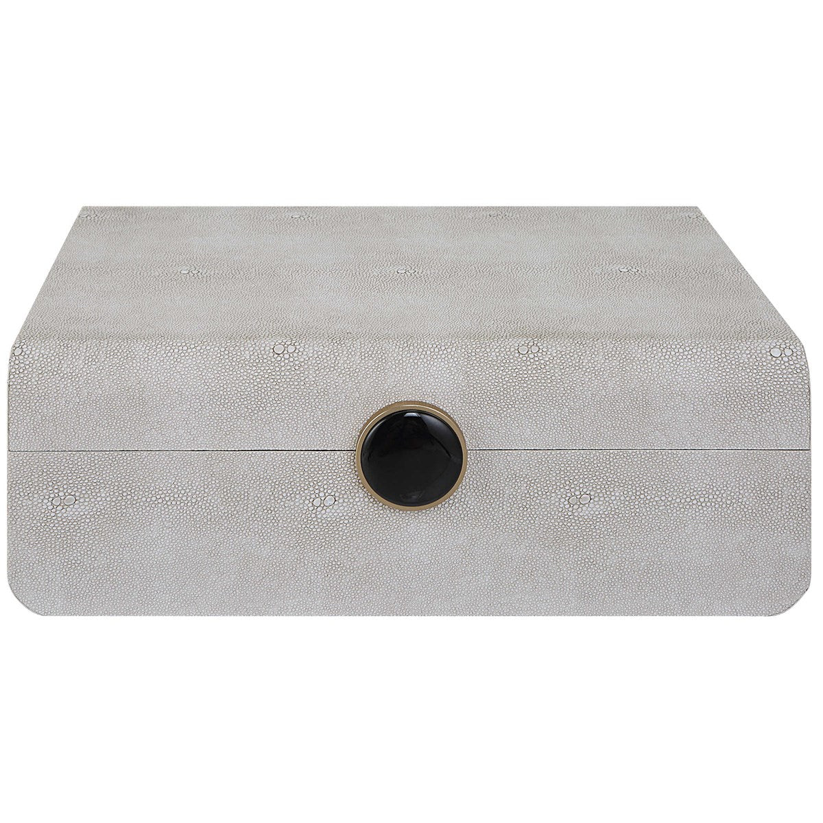 Closed white box with black button and gold trim surrounding the button. Box closed shut and displayed on an all white background. 