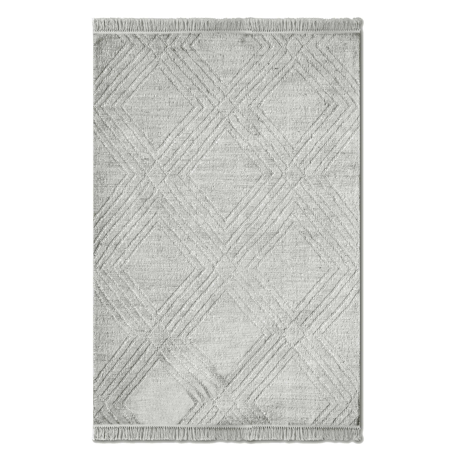 The whole white rug with tassel ends on a white background. 