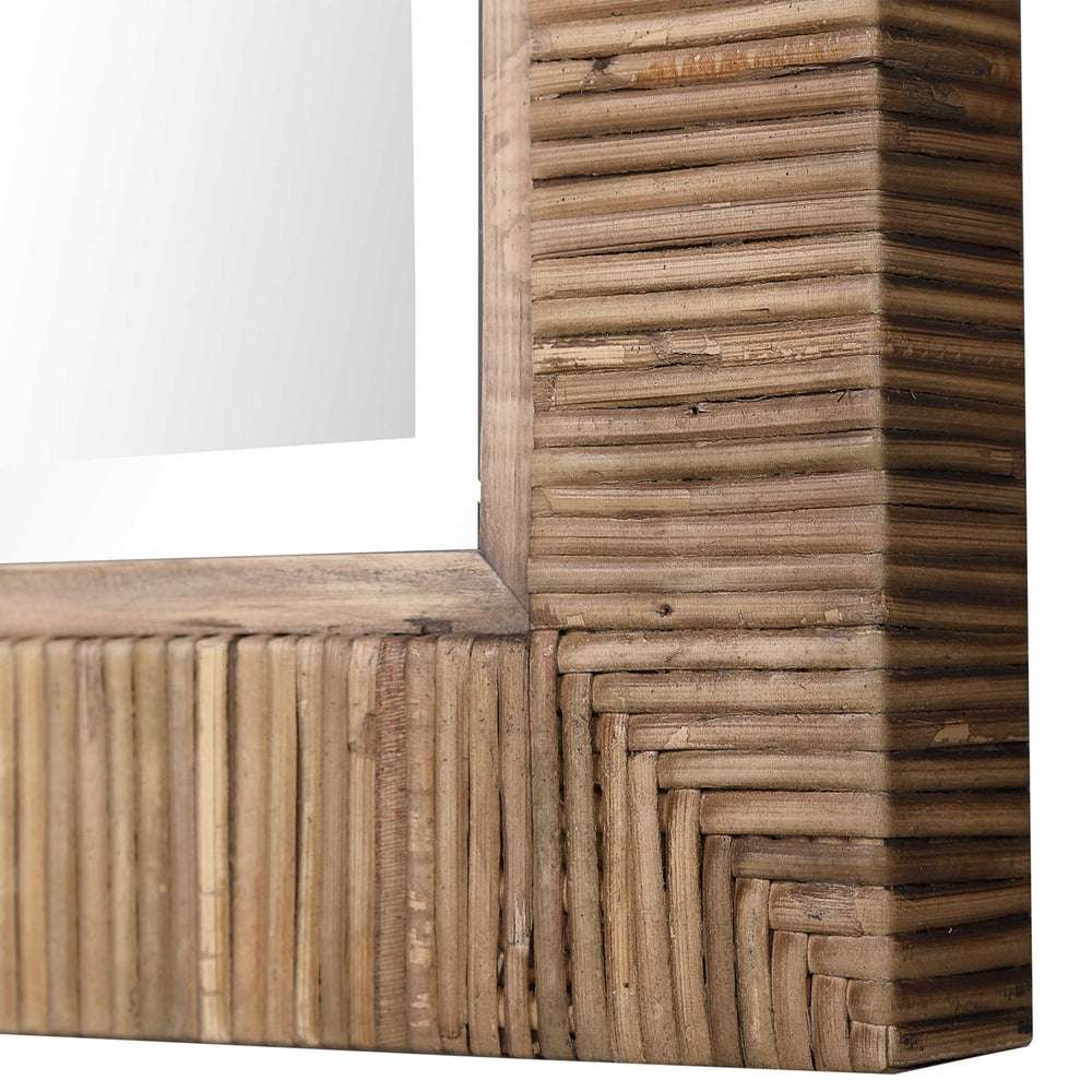 Rattan corner of mirror.