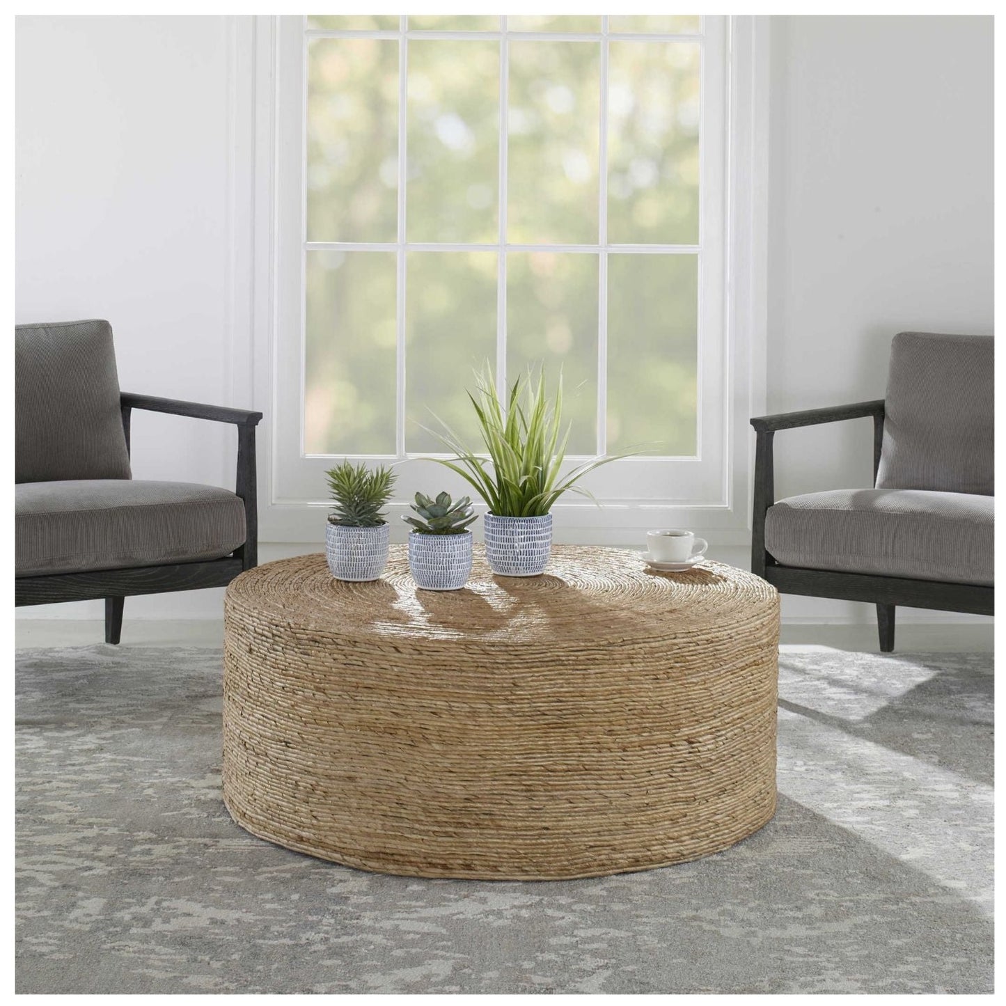 Room setting of this round coffee table with two chairs