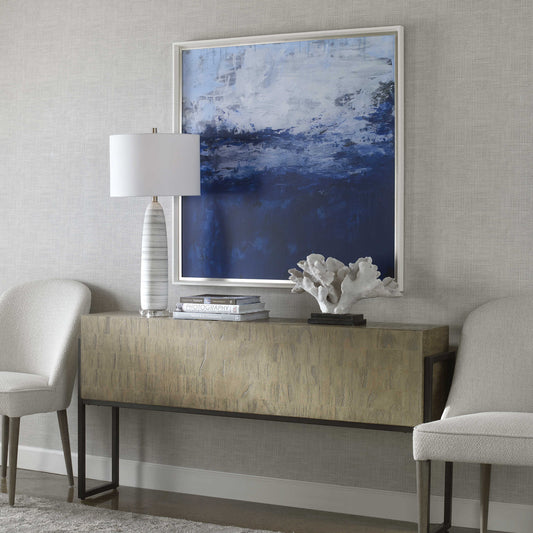 Abstract Ocean Sea Art with White Lamp and Coral Sculpture and Decorative Books on Gold Console Table.