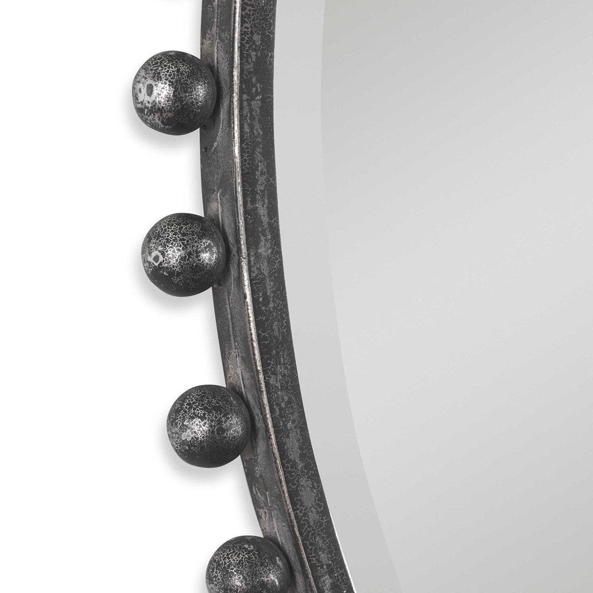 Close up of iron balls around exterior of black mirror.