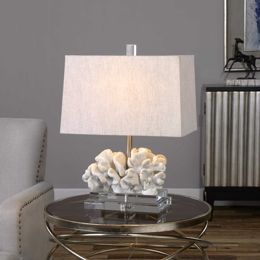 White coral lamp on a small e mirrored end table.