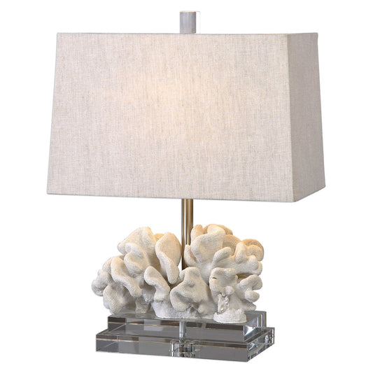 Coral table lamp shot in studio lighting with light on.