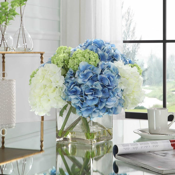 Fake Hydrangeas in clear glass case with faux water.